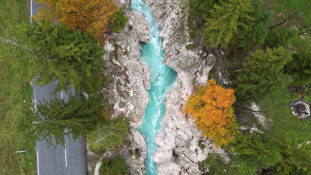 Aerial view of the Soča river through green Slovenian forest